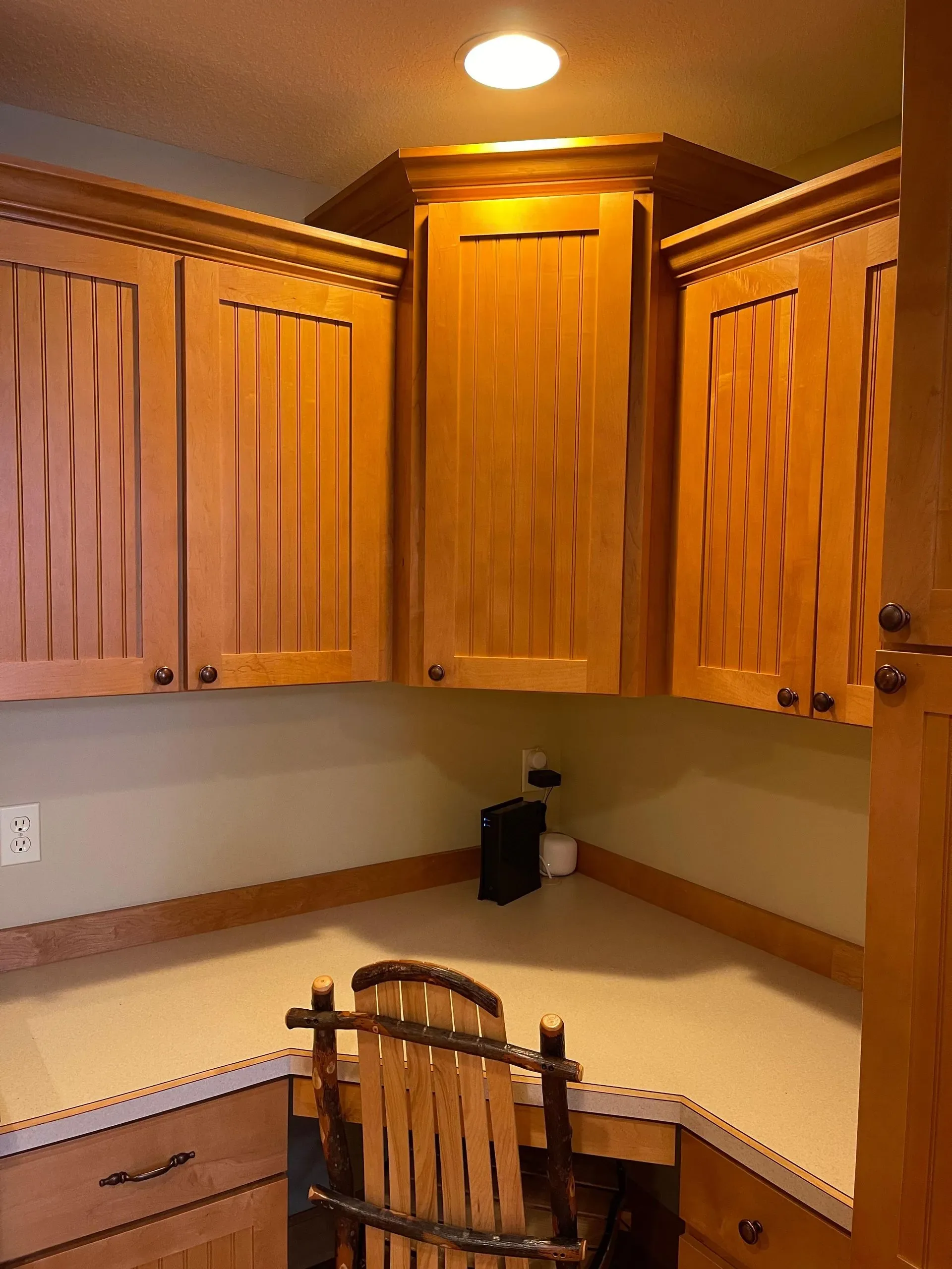 An image of a well lit kitchen with wooden kitchen cabinets